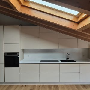 Cucina Moderna Beige in Mansarda con Travi a Vista e Design Minimal
